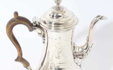 Good quality George III coffee pot of baluster form, with engraved armorial crest, hinged domed cover with acorn finial, fruitwood scroll handle and leaf mounted spout, on a circular