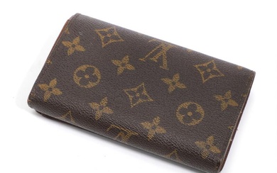 Louis Vuitton A wallet of brown monogram canvas with gold tone hardware,...