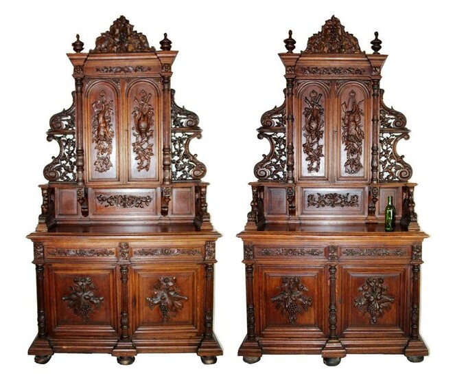 Pair of French carved oak hunt motif buffets