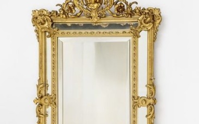 Spectacular mirror. Gilded, carved and stuccoed frame, fully...
