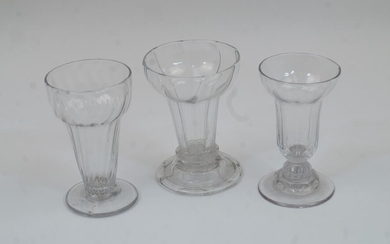Three various jelly glasses, mid 18th century, two with ribbed bodies, on spreading feet, 10.3cm high, together with one with pedestal foot (3)
