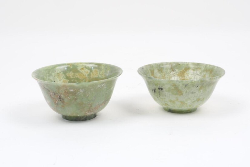 Two Chinese semi-translucent jadeite bowls, of typical form, each with...