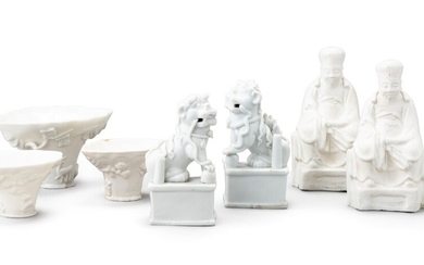 Two blanc de Chine figures of lion dogs and three blanc de Chine libation cups Qing dynasty, 17th-18th century | 清十七至十八世紀 德化白瓷佛獅、盃及 白瓷人物坐像 一組七件