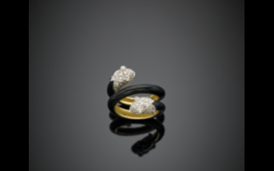 Yellow gold black enamel crossover ring terminated by two...