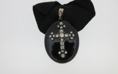A 19th century onyx and diamond mourning pendant