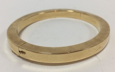 A Continental gold bangle of flattened circular form