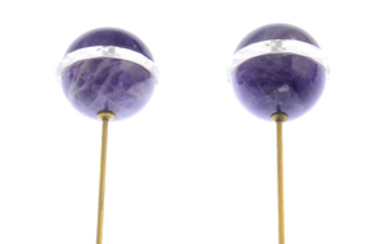 A pair of early 20th century amethyst and rock crystal hatpins.