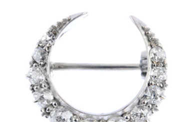 An early 20th century gold diamond crescent brooch. View more details