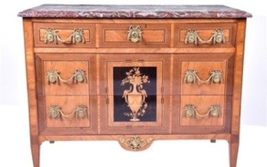 A Louis XVI marquetry and parquetry marble top commode comprising three drawers with ormolu handles designed as floral swags...