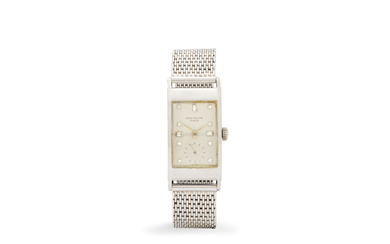 Patek Philippe. A very fine platinum rectangular wristwatch with diamond numerals and a platinum mesh bracelet