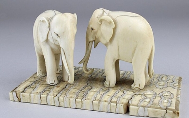 2 Indian elephants from ivory, India Beginning of the 20th century, elephant figures carved from ivory, 1 tusk missing in each, fine shrinkage cracks, one foot bumped, both mounted on plate from the molar of an elephant, H 7 cm, plate 12,2 x 8 cm...