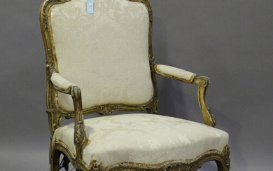 A 19th century French giltwood showframe fauteuil armchair with carved scroll decoration, on cabriol