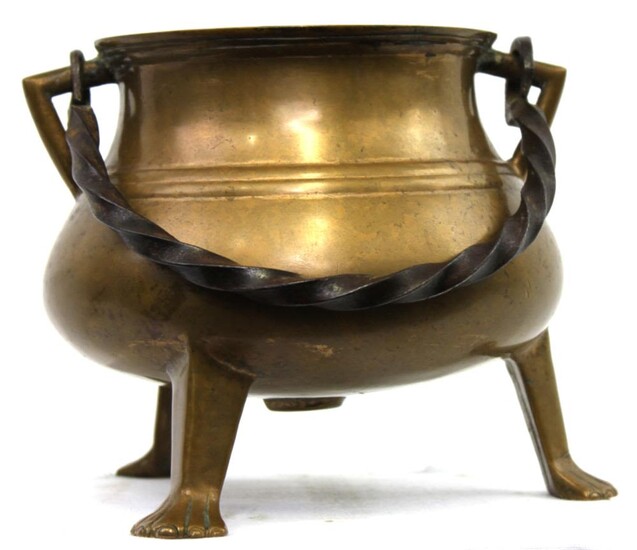 A Bronze Tripod Cauldron Circa 1600, with a spiral...
