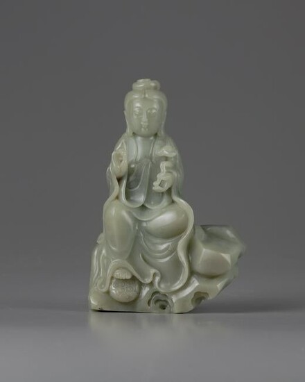 A CHINESE CELADON JADE CARVING OF A GUANYIN, CHINA
