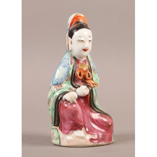A CHINESE PORCELAIN FAMILLE ROSE FIGURE of a kneeling female...