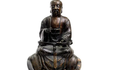 A Chinese bronze documentary figure of a seated official or Daoist deity...