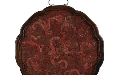 A Chinese carved cinnabar lobed 'dragon' plaque Mid Qing dynasty Finely carved...