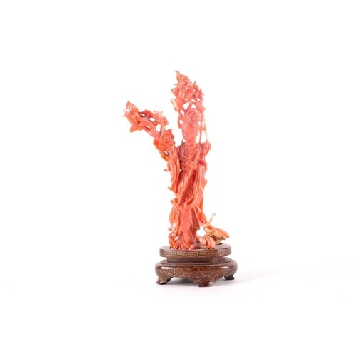 A Chinese coral figure of Lan Caihe, 20th century, dressed i...