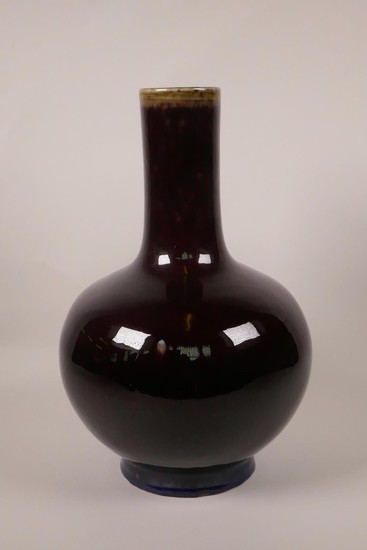 A Chinese pottery bottle vase with a flambé glaze, 4 charact...