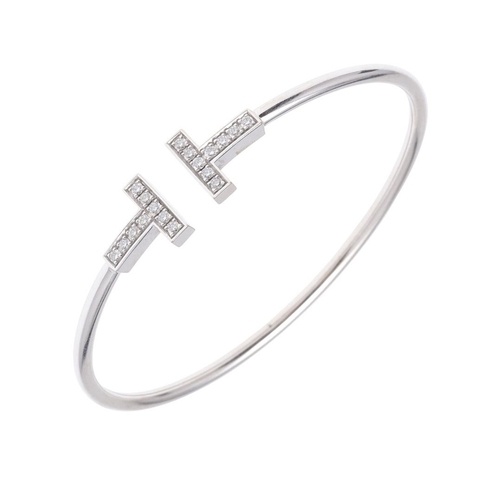 A DIAMOND AND 18CT WHITE GOLD 'T' BANGLE BY TIFFANY & CO. mo...