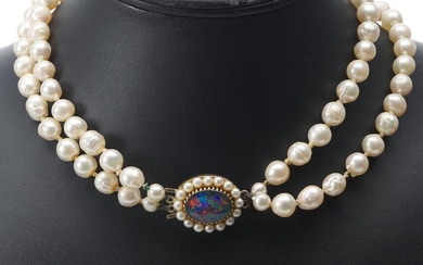 A DOUBLE STRAND OF CULTURED PEARLS MEASURING FROM 5.60 TO 8.16MM, THE CLASP SET WITH A BLACK OPAL DOUBLET IN 9CT GOLD, TOTAL LENGTH...