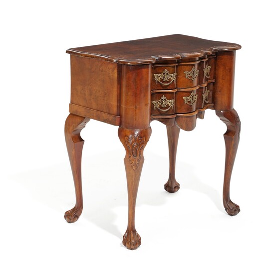 A Dutch early 20th century Baroque style walnut chest of drawers, curved front with two drawers. H. 74. W. 65. D. 42 cm.