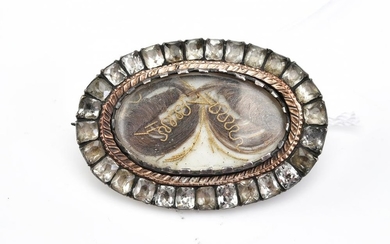 A GEORGIAN MOURNING BROOCH WITH HAIR DETAIL AND PASTE SURROUND