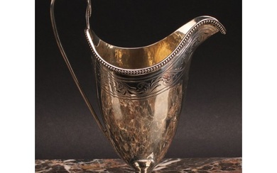 A George III silver helmet shaped cream jug, bright-cut engr...