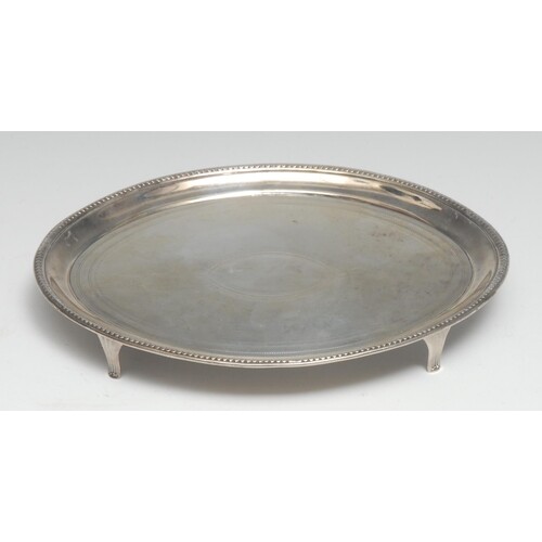 A George III silver oval teapot stand, outlined throughout w...