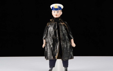 A German bisque shoulder head dolls’ house Royal Navy officer in oil-cloth coat