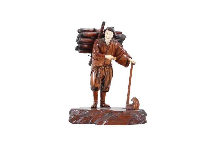 A JAPANESE IVORY AND HARDWOOD FIGURE OF A WOOD CUTTER, MEIJI PERIOD