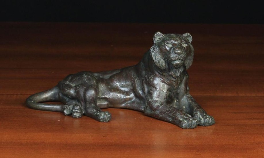A Japanese Bronze Study of a Reclining Lion 11'' (28 cm) in length.
