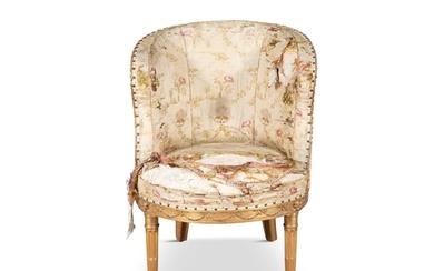 A LOUIS XVI CARVED GILTWOOD SMALL BERGERE, the silk uphols...