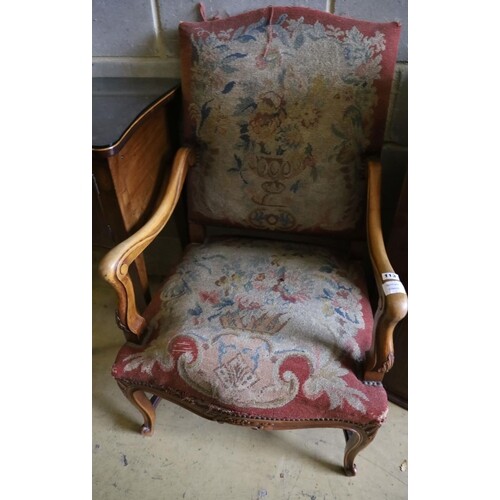 A Louis XIV style tapestry upholstered walnut framed fauteui...