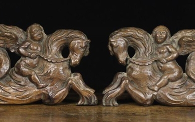 A Pair of 17th Century Pierced & Carved Oak Panels depicting winged cherubs riding on the backs of h