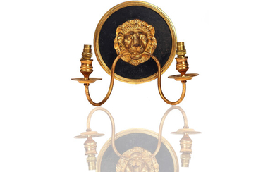 A SET OF FOUR FRENCH GILT AND BLACK PAINTED METAL TWIN-LIGHT WALL APPLIQUÉS