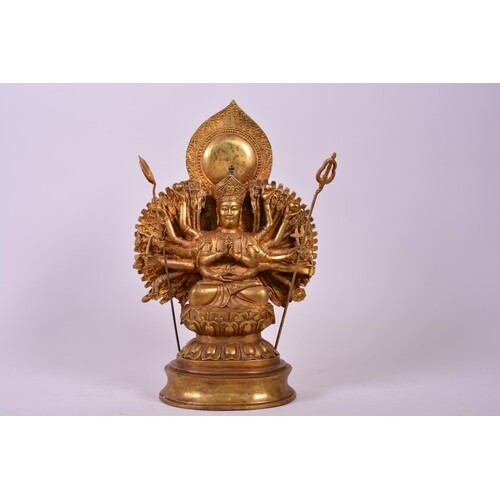 A Sino-Tibetan gilt bronzed metal figure of a many armed dei...