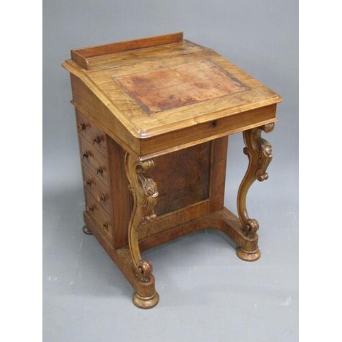 A Victorian figured walnut Davenport with hinged slope over ...