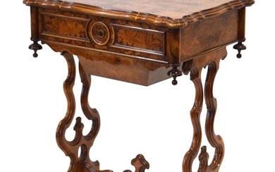 A Victorian figured walnut sewing table, the lid enclosing a...