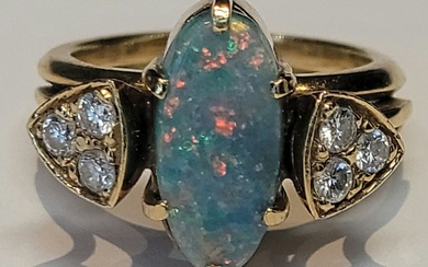 A black opal and diamonds ring in 18k yellow gold