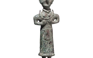 A bronze statuette of a woman with a crescent moon, Neo-Elamite, 8th - 7th century B.C.
