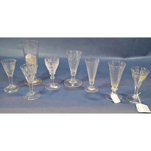A collection of eight Georgian stemmed glasses, with wrythen...