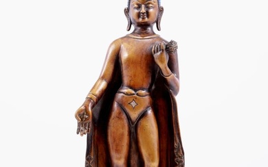 A copper inlaid silver statue of Gautama Buddha