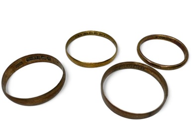 A group of four gold band rings. Comprising two 9ct...