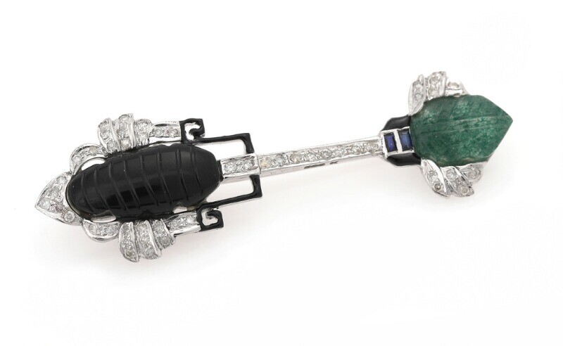 NOT SOLD. A jade, onyx and diamond brooch set with carved jade and onyx, numerous...