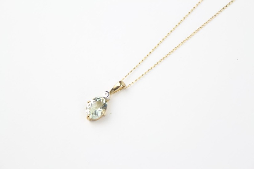 A ladies gold mounted aquamarine necklace, on a fine gold ch...