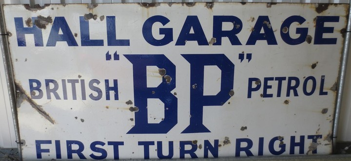 A large BP Hall Garage enamel sign