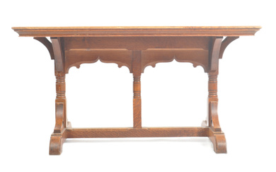 A late 19th century Gothic / ecclesiastical Arts & Crafts solid oak refectory dining table in the manner of Pugin. Raised on splayed feet united by a central stretcher with carved and pierced supports having inset spade decoration rising to...
