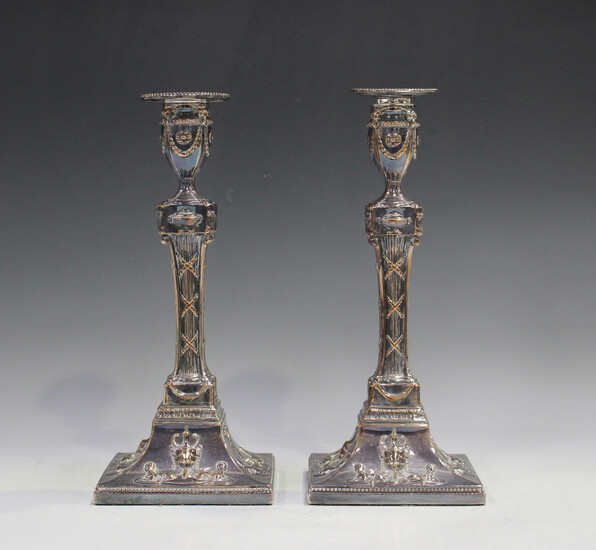 A pair of 19th century Sheffield plate candlesticks, each with a detachable beaded nozzle above an o