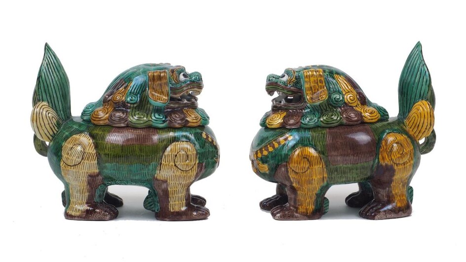 A pair of Chinese porcelain lion dog censers with covers, Ming style, in brown yellow and green colour ways, modelled with open mouths and upright tails, each censer 17cm high (2)